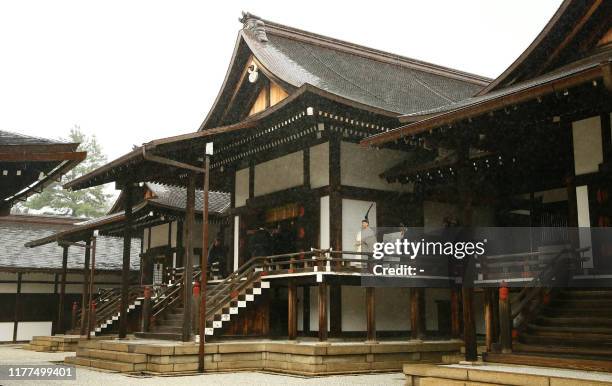 Japan's Emperor Naruhito walks to Kashikodokoro sanctuary to report the proclamation of his ascension to the throne to sun goddess in the ancient...