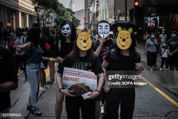 Protesters wearing masks gather at Canton Road during the anti-government march. Protesters defy demonstration ban, anti-mask law in Hong Kong and...