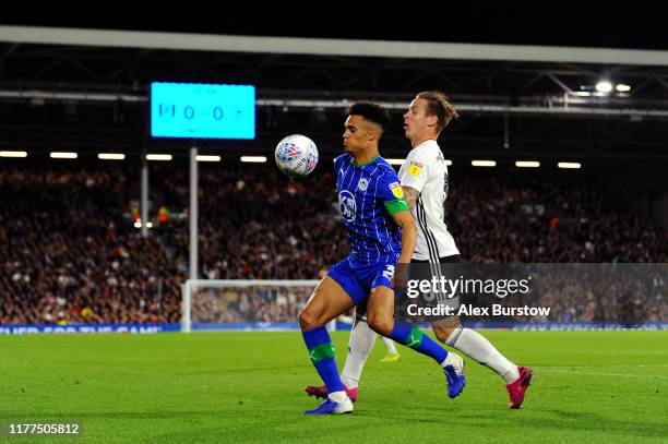 Antonee Robinson of Wigan Athletic battles for possession with Stefan Johansen of Fulham during the Sky Bet Championship match between Fulham and...