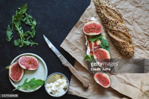 healthy sandwich with bread, cream cheese, prosciutto, figs - fig imagens e fotografias de stock