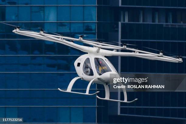 Volocopter unmanned air taxi transport flies over Marina Bay during test flight with a safety pilot at the 26th Intelligent Transport Systems World...