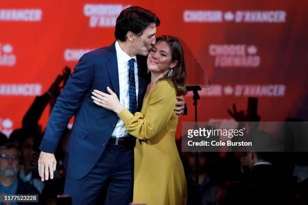 Liberal Leader and Canadian Prime Minister Justin Trudeau kisses his wife Sophie Grégoire Trudeau after delivering his victory speech at his election...