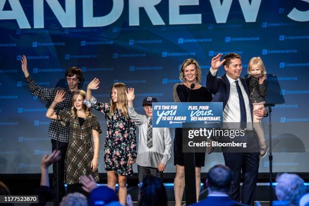 Andrew Scheer, leader of Canada's Conservative Party, right, waves as he stands with his family during a Conservative Party election night event in...