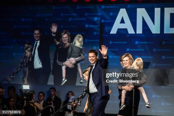 Andrew Scheer, leader of Canada's Conservative Party, center, waves as he walks on stage with his family during a Conservative Party election night...