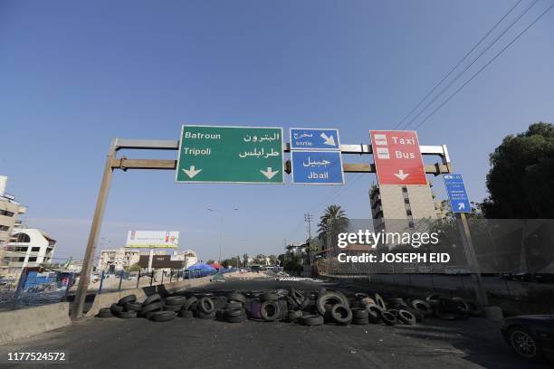Makeshift roadblock is set up by protesters on a road leading to major northern Lebanese cities , on October 22, 2019. - Lebanon's teetering...