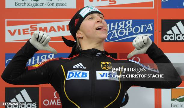 German women bob team pilot Cathleen Martini celebrates after the competition race of the Women Bob World Cup race in Schoenau, southern Germany, on...