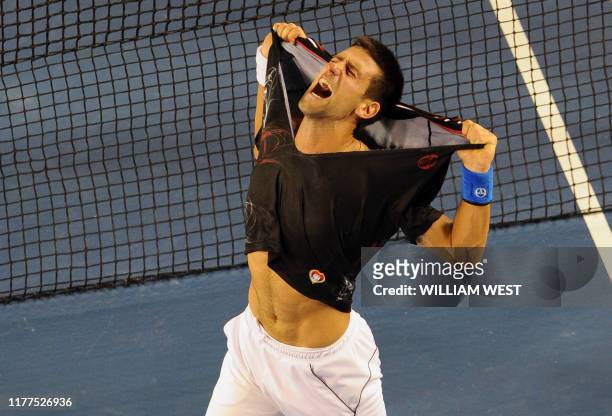 Novak Djokovic of Serbia rips his shirt off as he celebrates his victory over Rafael Nadal of Spain in the men's final match on day 14 of the 2012...