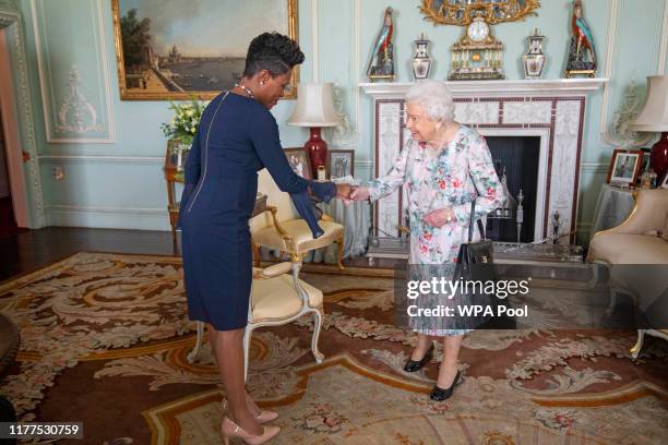 Queen Elizabeth II receives the High Commissioner for Grenada, Lakisha Grant, during a private audience at Buckingham Palace on October 22, 2019 in...