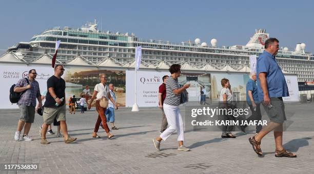 Tourists disembark at Doha Port as a new cruise season kicks off with the launch of a new temporary passenger terminal as Qatar works to increase the...