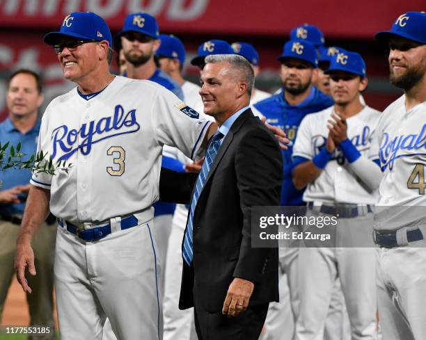 Manager Ned Yost of the Kansas City Royals stands with general manager Dayton Moore during a ceremony honoring his career in baseball prior to a game...