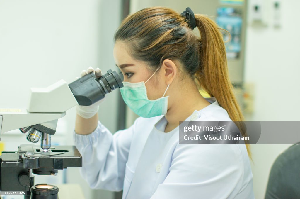 Forensic Laboratory Worker Studying Samples With Refractometer And ...