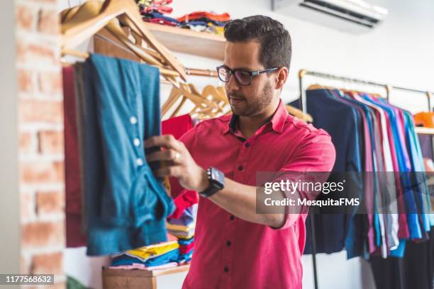 man choosing clothes - multi coloured shirt stock pictures, royalty-free photos & images