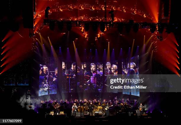 Vince Gill, Timothy B. Schmit, Don Henley, Scott F. Crago, Deacon Frey, Joe Walsh and Steuart Smith of the Eagles perform with an orchestra at MGM...