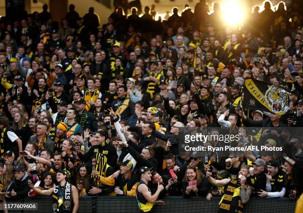 Daniel Rioli, Jason Castagna and Nathan Broad of the Tigers celebrate after the 2019 AFL Grand Final match between the Richmond Tigers and the...