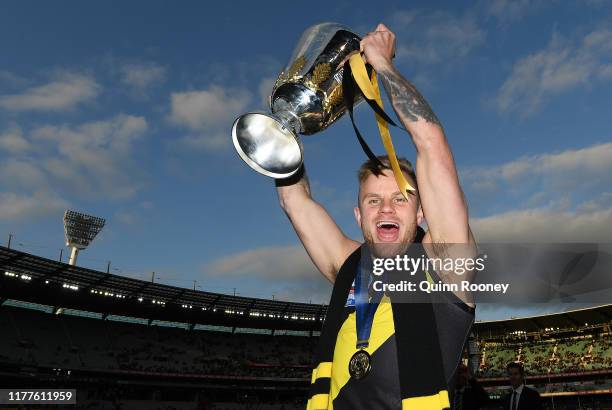 Brandon Ellis of the Tigers celebrates with the Premiership Trophy during the 2019 AFL Grand Final match between the Richmond Tigers and the Greater...