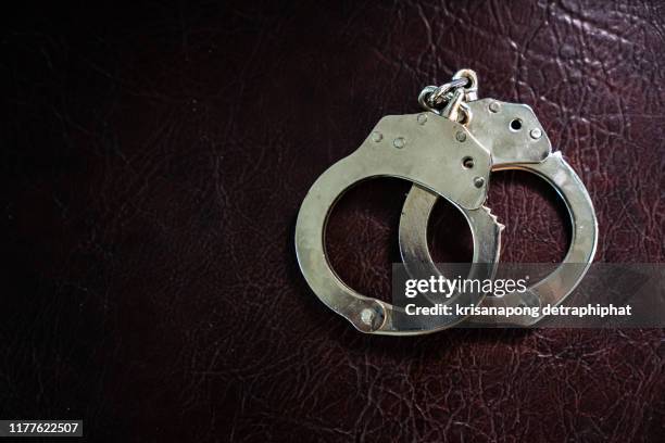 police handcuffs,shackle - crime or recreational drug or prison or legal trial fotografías e imágenes de stock