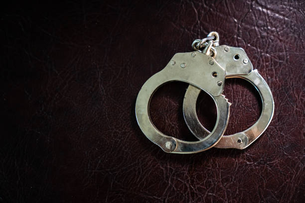 police handcuffs,shackle - arrest stock pictures, royalty-free photos & images