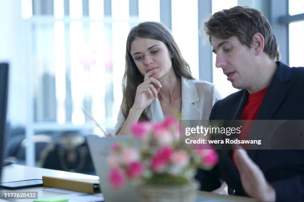 concentration of business talking with partnership isolated over blurred background - femme entre deux hommes photos et images de collection
