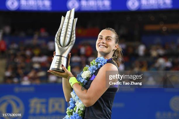 Aryna Sabalenka of Belarus poses with her trophy after defeating Alison Riske of the United States during 2019 Wuhan Open singles final match at...