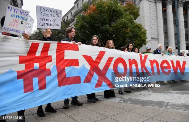 Climate activists protest on the first day of the Exxon Mobil trial outside the New York State Supreme Court building on October 22, 2019 in New York...