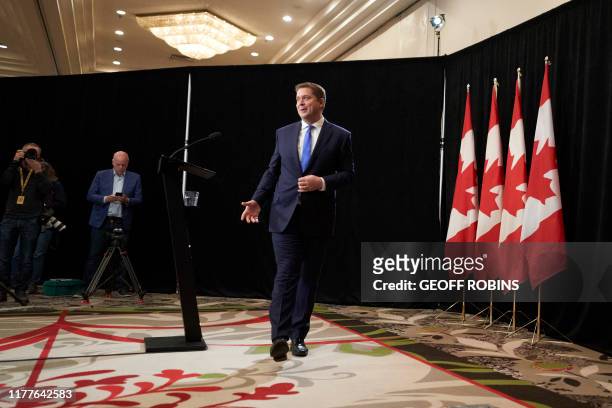 Conservative leader Andrew Scheer walks away following a press conference in Regina, Saskatchewan, October 22, 2019. - A weakened Prime Minister...