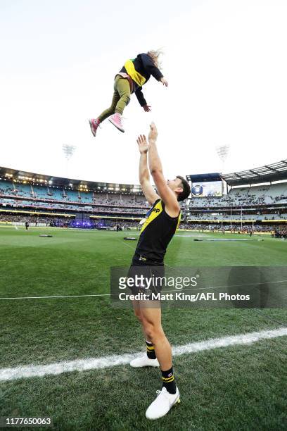 Trent Cotchin of the Tigers celebrates victory with his daughter after the 2019 AFL Grand Final match between the Richmond Tigers and the Greater...