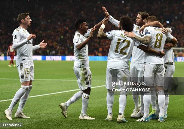 Real Madrid's German midfielder Toni Kroos celebrates with team mates after he scored a goal during the UEFA Champions League group A football match...