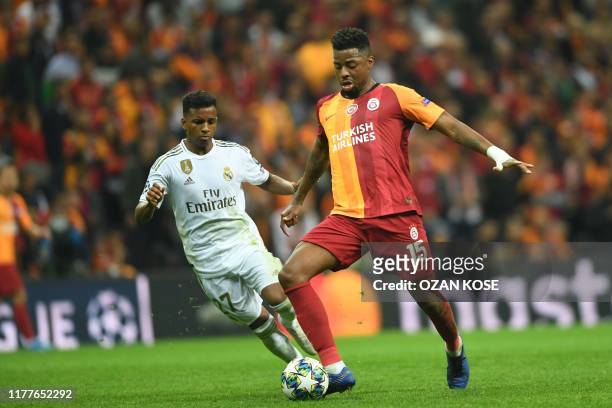 Galatasaray's Dutch midfielder Ryan Donk vies for the ball with Real Madrid's Brazilian forward Rodrygo during the UEFA Champions League group A...