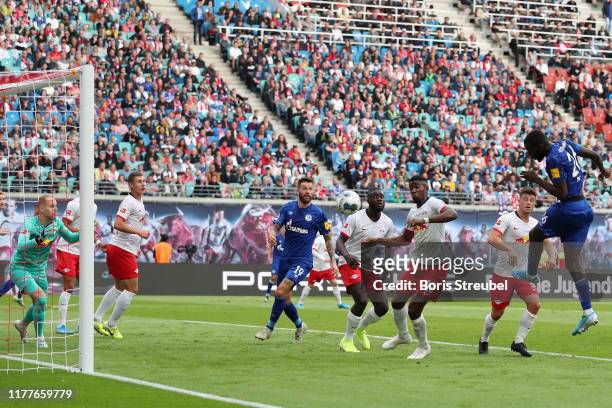 Salif Sane of FC Schalke 04 scores his team's first goal during the Bundesliga match between RB Leipzig and FC Schalke 04 at Red Bull Arena on...