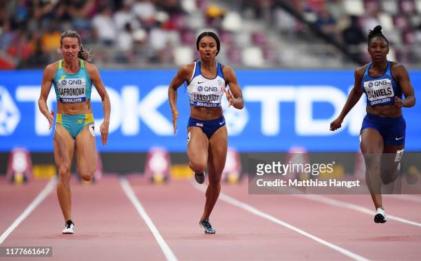 Olga Safronova of Kazakhstan, Imani Lansiquot of Great Britain and Teahna Daniels of the United States compete in the Women's 100m heats during day...
