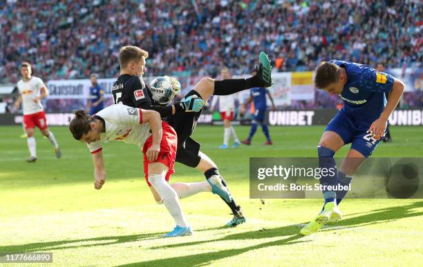 Alexander Nuebel of FC Schalke 04 catches the ball under pressure from Marcel Sabitzer of RB Leipzig during the Bundesliga match between RB Leipzig...