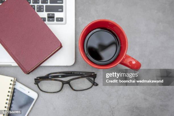 modern office desk table with laptop, smartphone and other supplies with cup of coffee. blank notebook page for input the text in the middle. top view, flat lay. - office work flat lay stock pictures, royalty-free photos & images