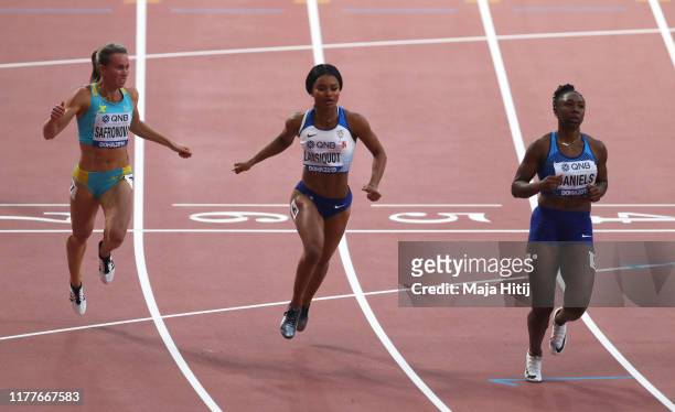 Olga Safronova of Kazakhstan, Imani Lansiquot of Great Britain and Teahna Daniels of the United States compete in the Women's 100m heats during day...