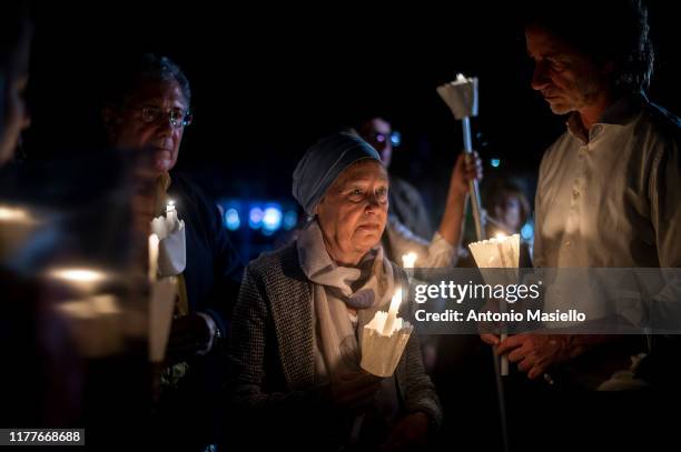 Stefano Cucchi's mother and father, Rita Calore and Giovanni Cucchi take part in a torchlight memorial to remember the tenth anniversary of the death...