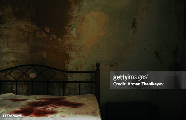 a gloomy room with bloodstained mattress on the bed. - killing stock pictures, royalty-free photos & images