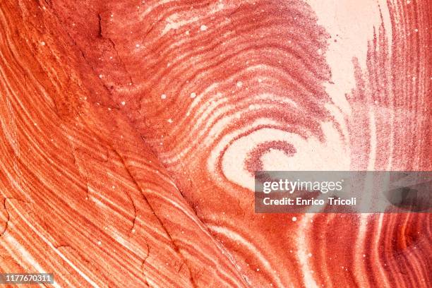 jordan: rock face of petra, with red, yellow and orange stripes that look like wood. warm light, background, wallpaper. - pink sandstone stock pictures, royalty-free photos & images