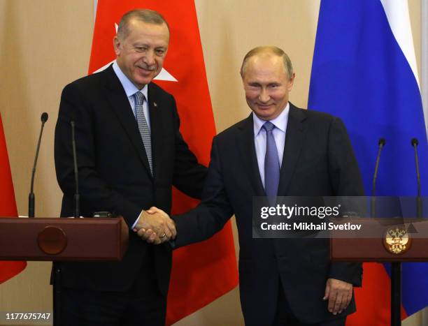 Russian President Vladimir Putin shakes hands with Turkish President Recep Tayyip Erdogan during their joint press conference after Russian-Turkish...