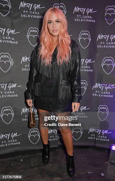 Lottie Tomlinson attends the launch of Nasty Gal Ft. Cara Delevingne, a collection of holiday-ready pieces inspired by female rock icons of the ages...