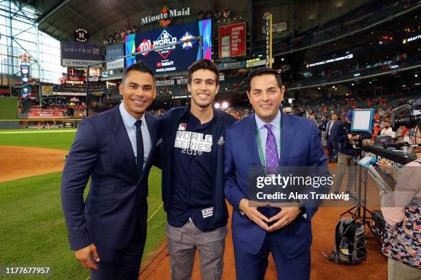 Major League Baseball Make-A-Wish invitee Logan Carman poses for a photo with MLB Network hosts Carlos Pena and Robert Flores prior to Game 1 of the...
