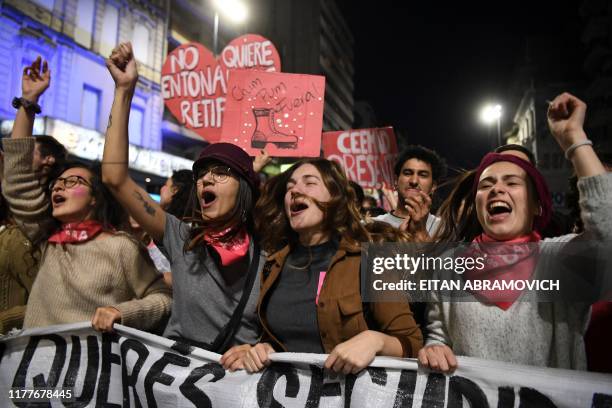 People demonstrate against a controversial security reform bill due to be voted in the upcoming October 27 general election, in Montevideo, on...