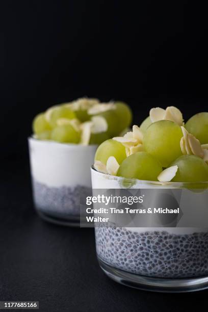 two chia desserts with quark and grapes on a dark background. - schist stock-fotos und bilder