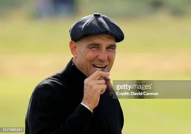 Vinnie Jones of England the former soccer star and Hollywood actor enjoys a cigar on the tee during the third round of the Alfred Dunhill Links...