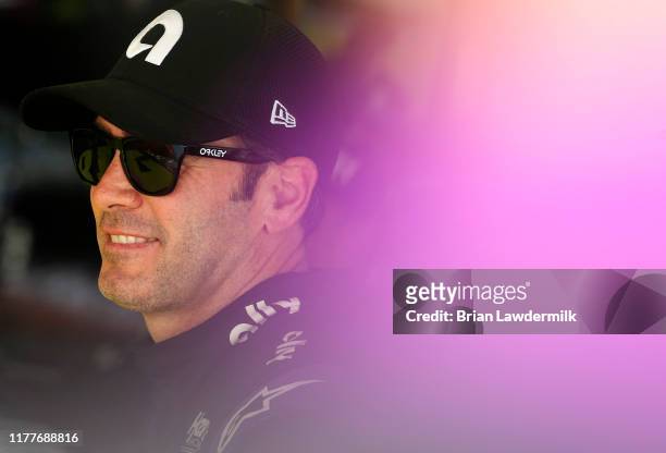 Jimmie Johnson, driver of the Ally Chevrolet, stands in the garage area during practice for the Monster Energy NASCAR Cup Series Bank of America...