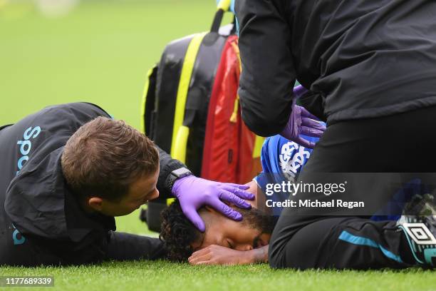 Theo Walcott of Everton receives medical treatment during the Premier League match between Everton FC and Manchester City at Goodison Park on...