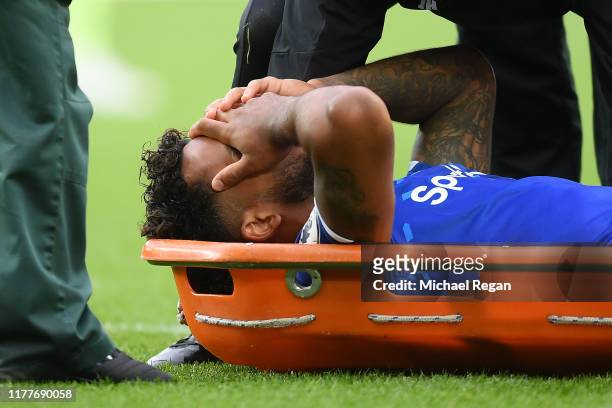 Theo Walcott of Everton receives medical treatment after he is hit on the head from a ball after a cross by Raheem Sterling of Manchester City during...
