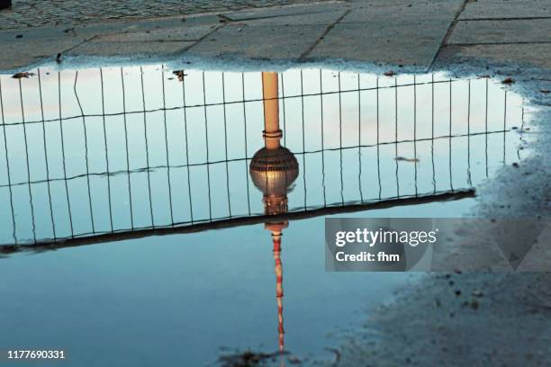 berlin television tower - reflection in a puddle (germany) - berlin fernsehturm stock pictures, royalty-free photos & images