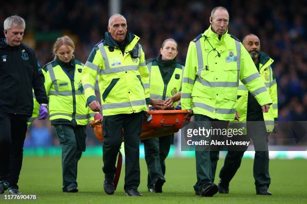 Theo Walcott of Everton is stretchered off after sustaining a head injury during the Premier League match between Everton FC and Manchester City at...