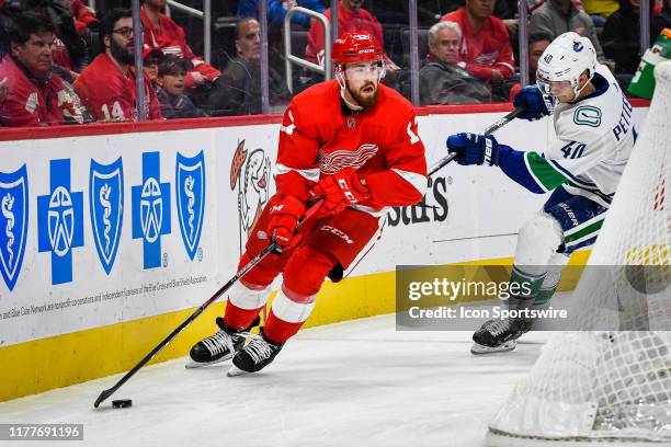 Detroit Red Wings defenseman Filip Hronek comes out from behind the net with the puck during the Detroit Red Wings game versus the Vancouver Canucks...