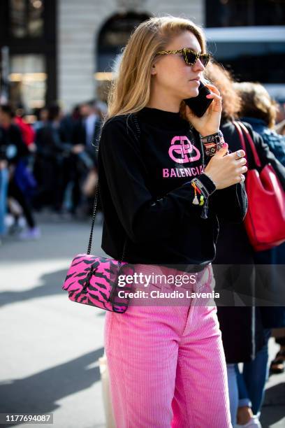 Jessica Minkoff, wearing a black Balenciaga sweatshirt, fuchsia pants and Yves Saint Laurent bag, is seen outside the Balmain show during Paris...