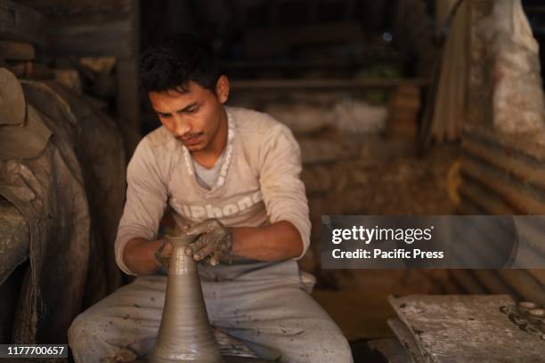 Potter making clay pot lamps for Tihar or Deepawali Festival of lights, at Pottery Square.